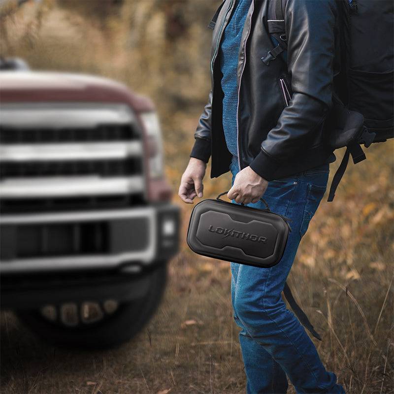 Person carrying LOKITHOR EVA case near truck